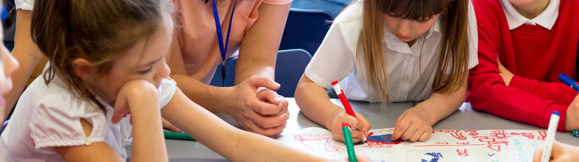 teacher working on activity with students — How to Create a Lesson Plan